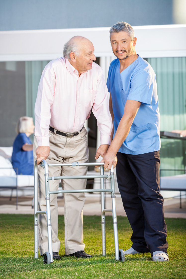 Smiling Caretaker Assisting Senior Man 
