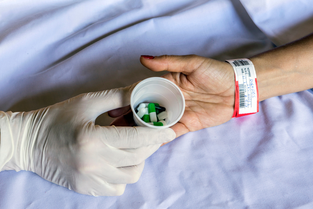 Nurse giving a patient a dose of daily medication